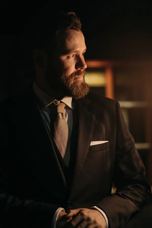 Security professional in a suit, watching the room